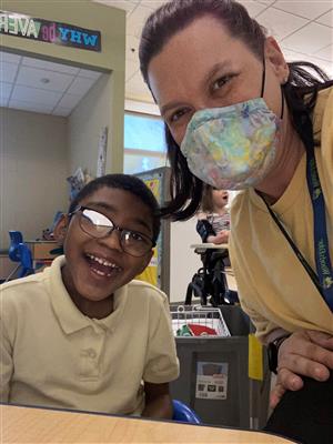 Teacher Ann-Marie posing with a student